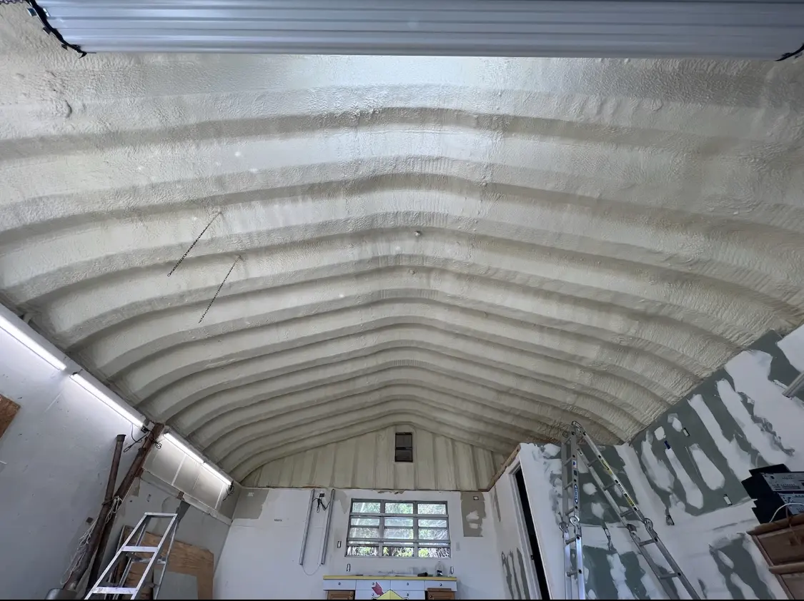 Spray polyurethane foam applied to the underside of a metal roof deck in Waterford